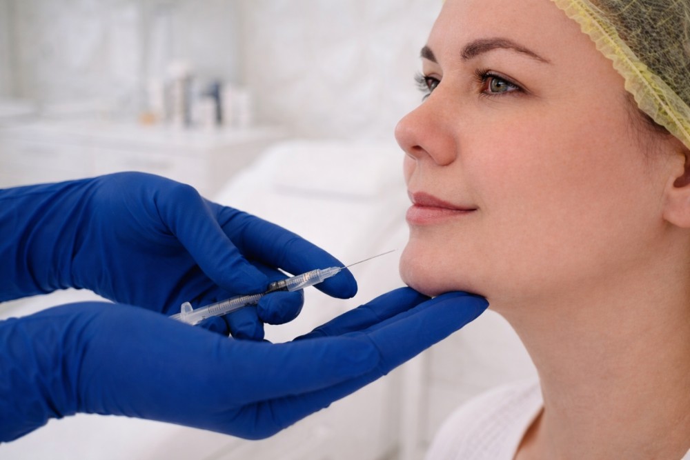 Paciente de Infinity Clinic recibiendo tratamiendo de ácido hialurónico para su mentón